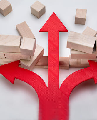 An arrow breaks through a wall of wooden blocks
